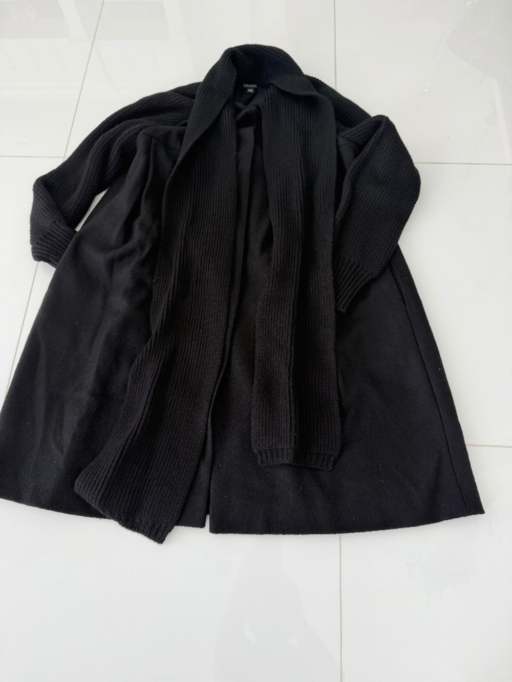 Black wool coat with black knit wool attached scarf and detail on back of coat.